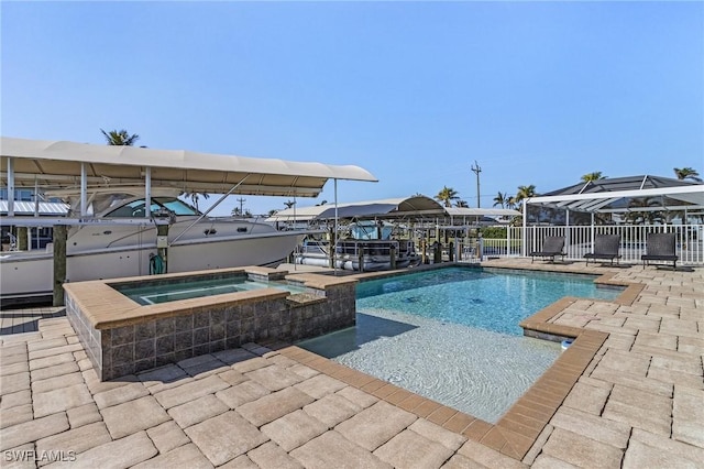 view of pool with an in ground hot tub and a patio