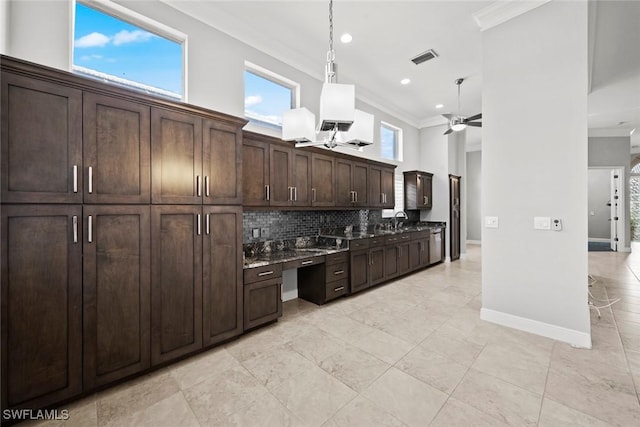 kitchen featuring tasteful backsplash, ornamental molding, dark brown cabinets, and ceiling fan