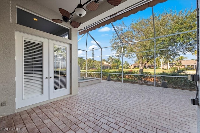 view of patio featuring a hot tub, glass enclosure, ceiling fan, and french doors