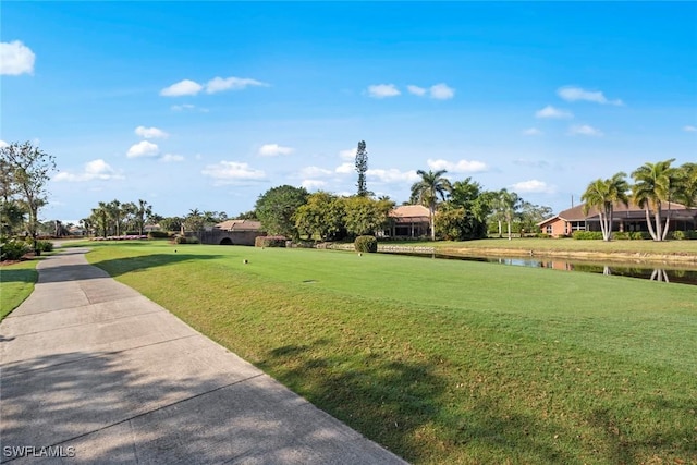 view of community featuring a water view and a lawn