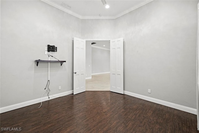 empty room with crown molding and wood-type flooring