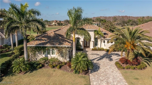 mediterranean / spanish home featuring a front yard