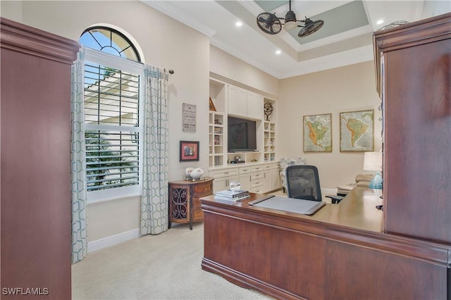 office space with crown molding, a healthy amount of sunlight, a tray ceiling, and light carpet