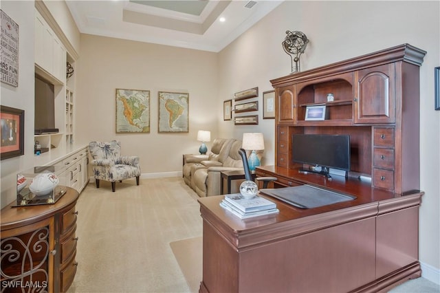 carpeted office space featuring a raised ceiling and crown molding