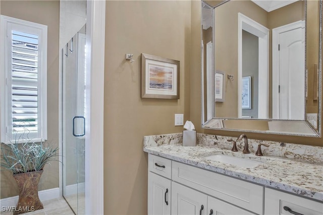 bathroom featuring vanity and an enclosed shower