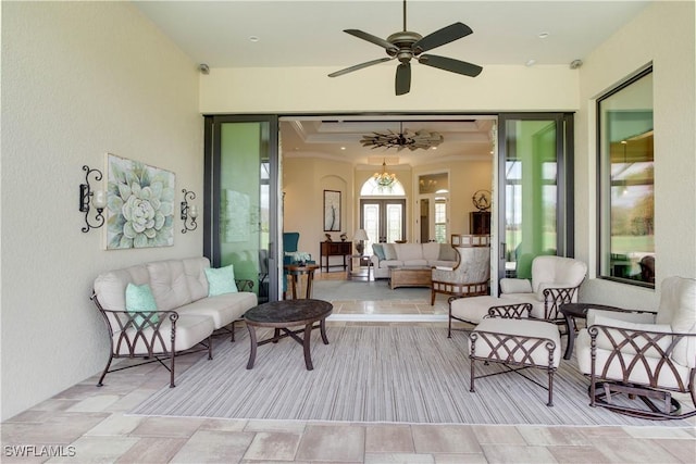 interior space featuring french doors, ceiling fan, and a tray ceiling