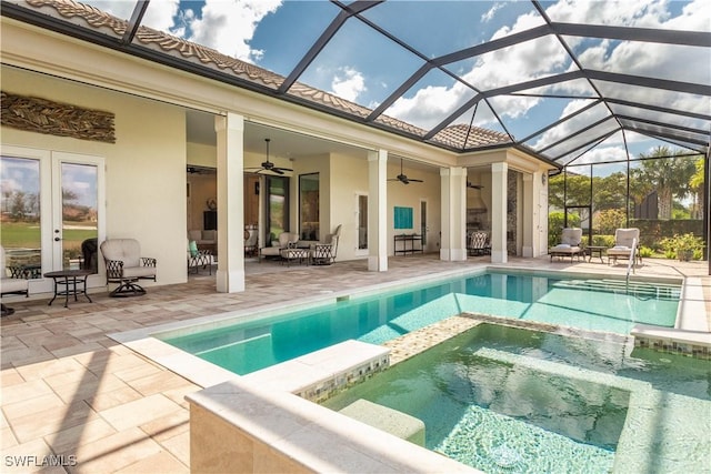 view of swimming pool with a lanai, a patio area, ceiling fan, and an in ground hot tub