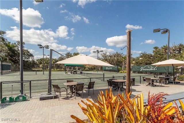 view of property's community featuring tennis court