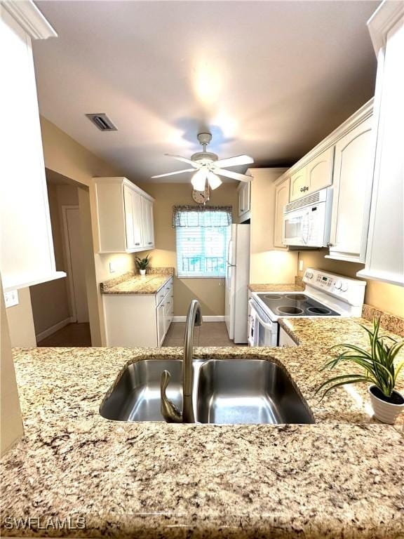 kitchen featuring white cabinetry, sink, ceiling fan, kitchen peninsula, and white appliances