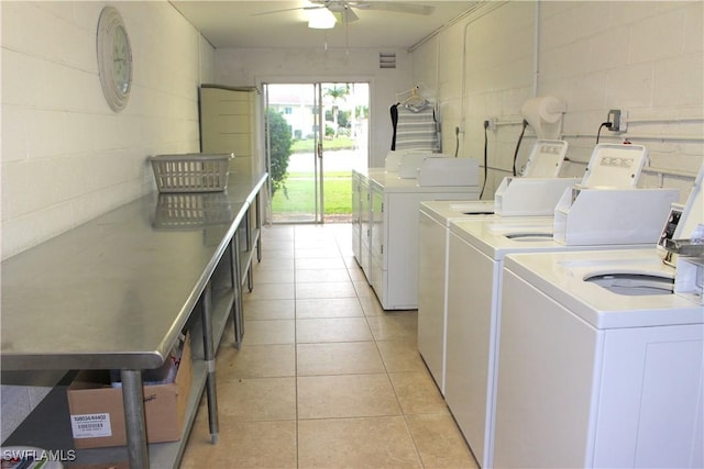 clothes washing area with light tile patterned floors, washer and clothes dryer, and ceiling fan