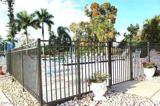 view of gate with a community pool