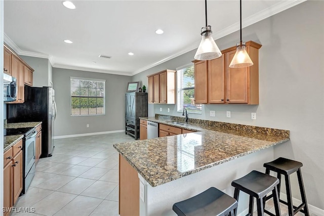 kitchen with decorative light fixtures, kitchen peninsula, dark stone counters, and appliances with stainless steel finishes