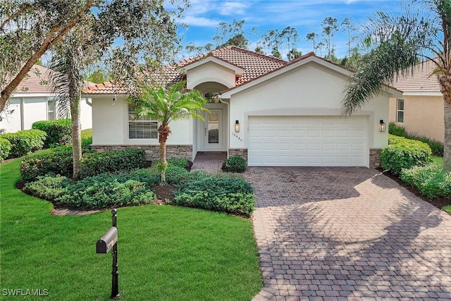 mediterranean / spanish-style house with a garage and a front yard