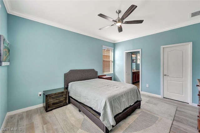 bedroom with crown molding, ceiling fan, ensuite bath, and light hardwood / wood-style flooring