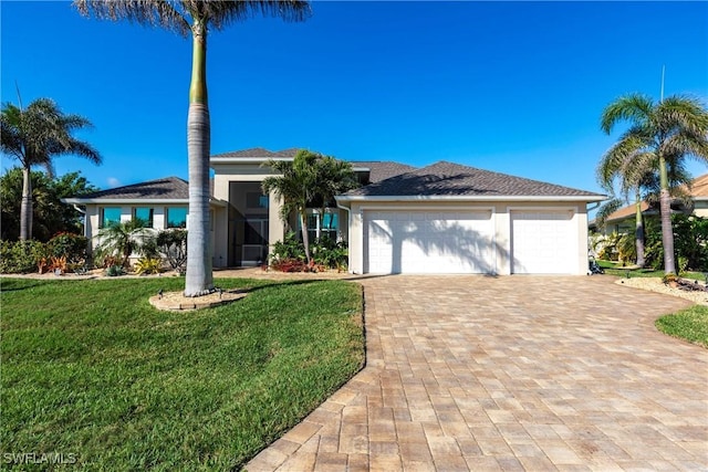 view of front of house featuring a garage and a front lawn