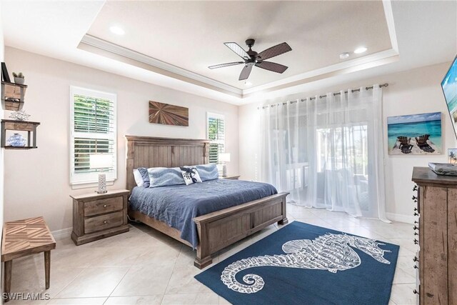 tiled bedroom featuring multiple windows, crown molding, and a raised ceiling