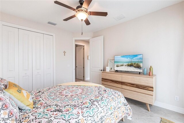 bedroom featuring tile patterned floors, a closet, and ceiling fan