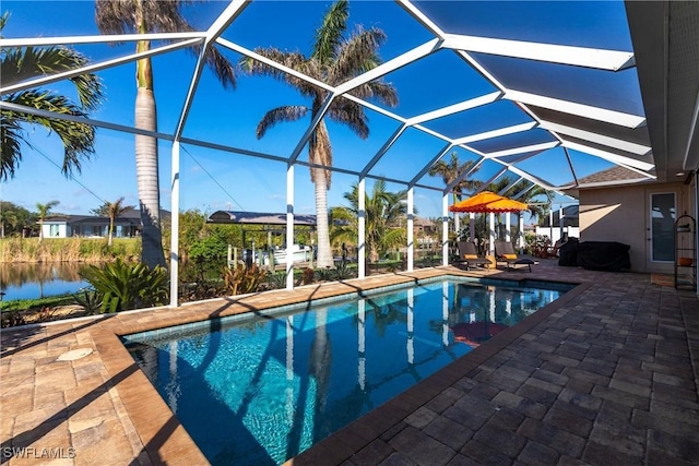 view of pool featuring a water view, a lanai, and a patio area