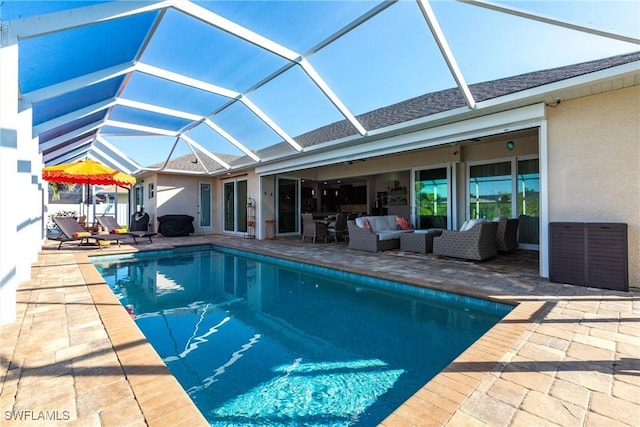 view of swimming pool with an outdoor living space, a patio, and glass enclosure