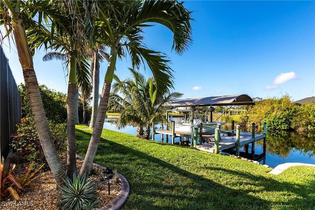 view of dock with a water view and a lawn