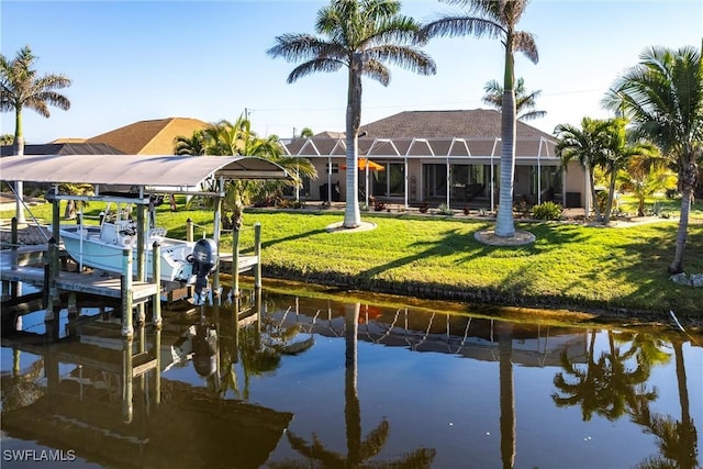 view of dock with a water view, a yard, and a lanai