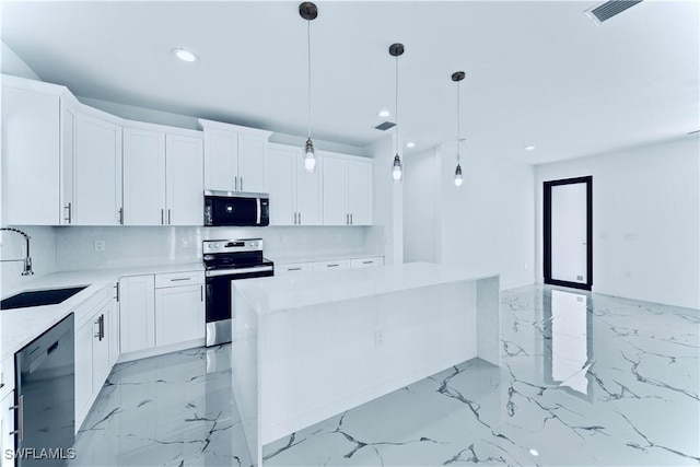 kitchen featuring sink, stainless steel appliances, white cabinets, and a kitchen island