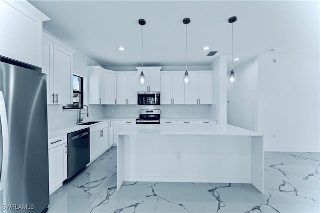 kitchen with white cabinetry, appliances with stainless steel finishes, a center island, and sink