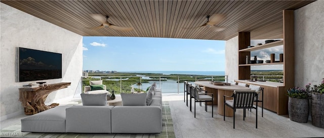 balcony featuring a water view, outdoor lounge area, an outdoor bar, and ceiling fan