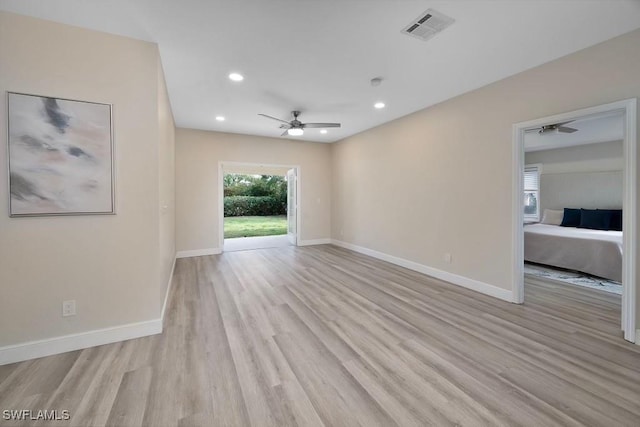 spare room featuring ceiling fan and light hardwood / wood-style floors