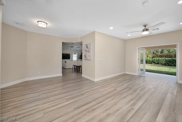 unfurnished living room featuring ceiling fan and light wood-type flooring