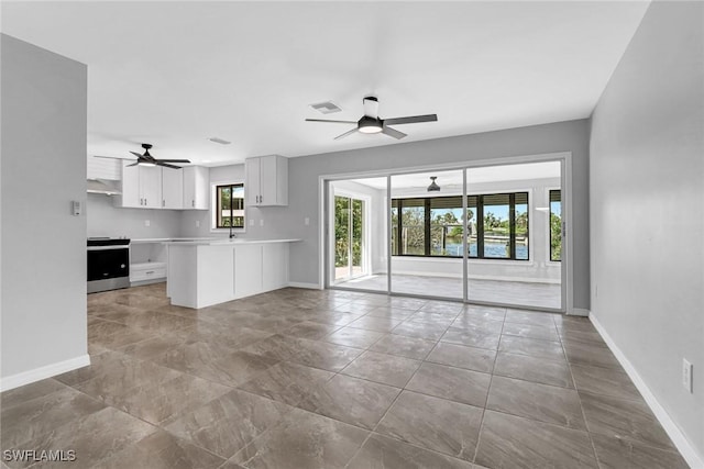 kitchen featuring ceiling fan, ventilation hood, white cabinets, stainless steel electric range oven, and kitchen peninsula