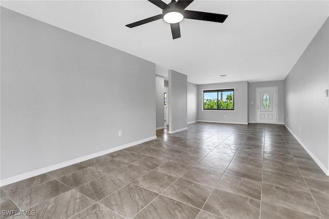 unfurnished living room with ceiling fan