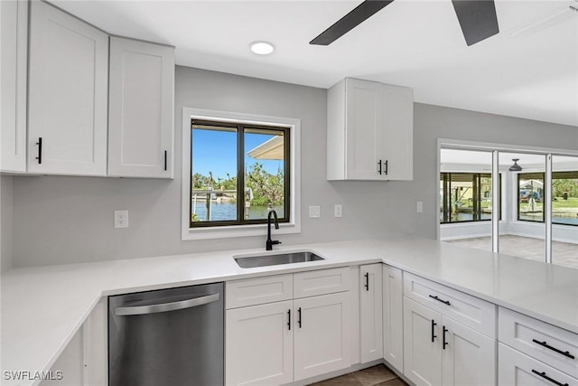 kitchen with white cabinetry, dishwasher, and sink