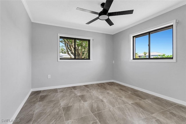 spare room featuring ceiling fan, crown molding, and a healthy amount of sunlight