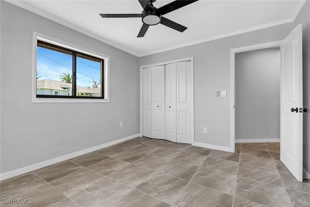 unfurnished bedroom featuring crown molding, ceiling fan, and a closet