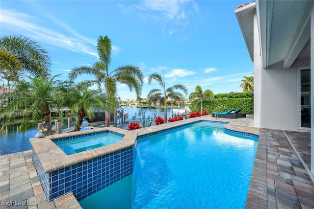 view of swimming pool featuring an in ground hot tub, a water view, and a patio area