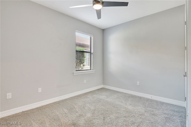 carpeted spare room with ceiling fan