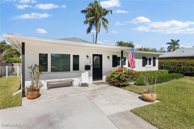 ranch-style home with a front lawn