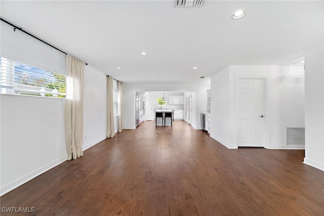 unfurnished living room featuring dark hardwood / wood-style floors