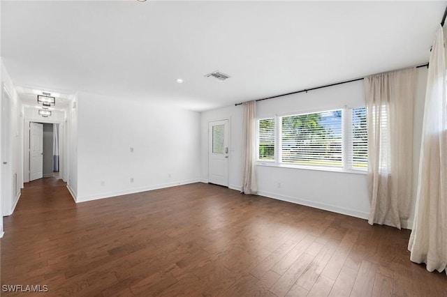 unfurnished room featuring dark hardwood / wood-style flooring