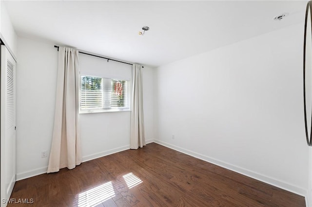 unfurnished bedroom featuring dark wood-type flooring