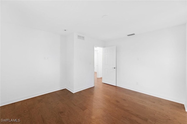 spare room with hardwood / wood-style floors