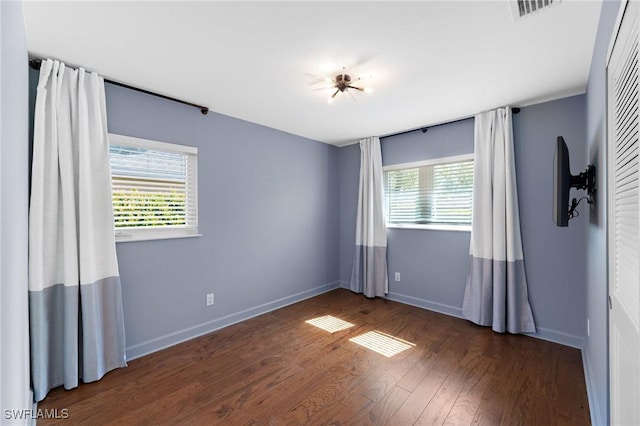 unfurnished room with dark hardwood / wood-style floors