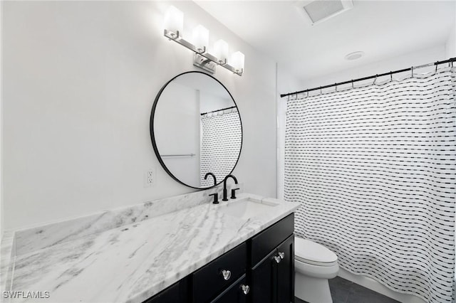 bathroom with vanity, toilet, and curtained shower