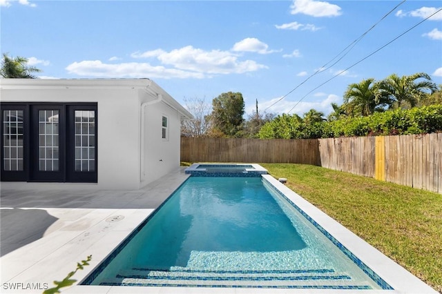 view of swimming pool featuring a lawn, a patio, and an in ground hot tub