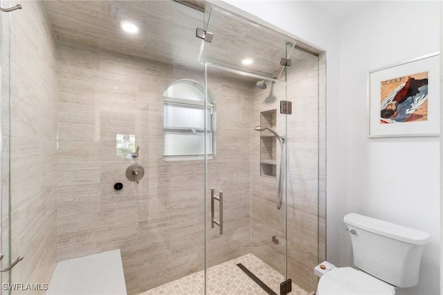 full bathroom with a stall shower, toilet, and recessed lighting