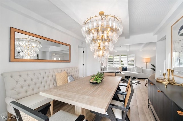 dining area with an inviting chandelier and beamed ceiling