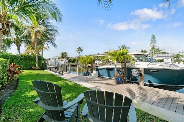 view of dock with a water view and a lawn