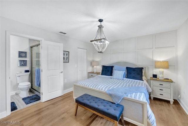 1533 San Marco Rd, Marco Island, FL 34145 - bedroom featuring light wood-style flooring, ensuite bathroom, baseboards, visible vents, and an inviting chandelier