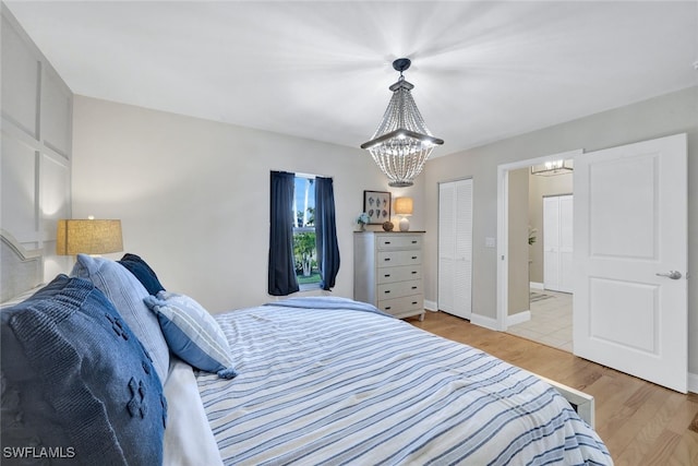 1533 San Marco Rd, Marco Island, FL 34145 - bedroom featuring a notable chandelier, baseboards, and wood finished floors
